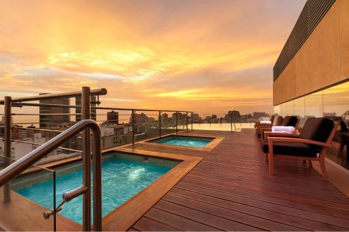 a balcony with two hot tubs on top of a building at Hilton Lima Miraflores in Lima