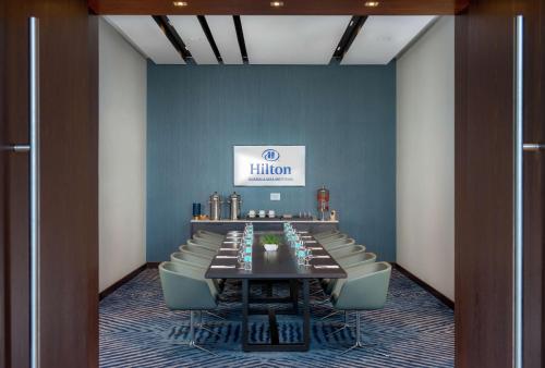a conference room with a long table and chairs at Hilton Guadalajara Midtown in Guadalajara