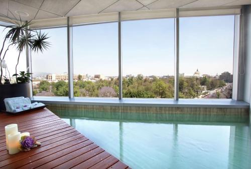 a swimming pool in a building with windows at Hilton Mexico City Reforma in Mexico City