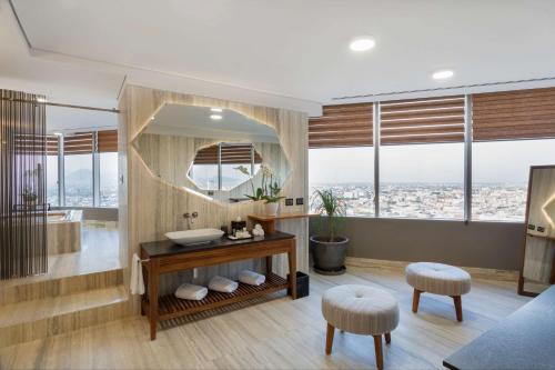 a bathroom with a large mirror and a sink at Hilton Mexico City Reforma in Mexico City