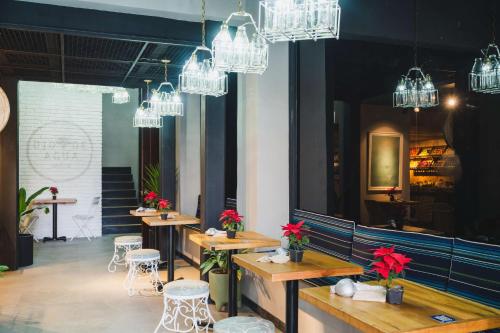 a restaurant with tables and chairs and chandeliers at Umbral, Curio Collection By Hilton in Mexico City