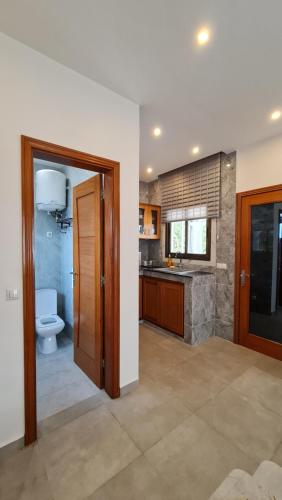 a bathroom with a toilet and a sink at KBK Lodge in Abaga