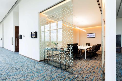 a dining room with a table and chairs at Hilton Garden Inn Merida in Mérida