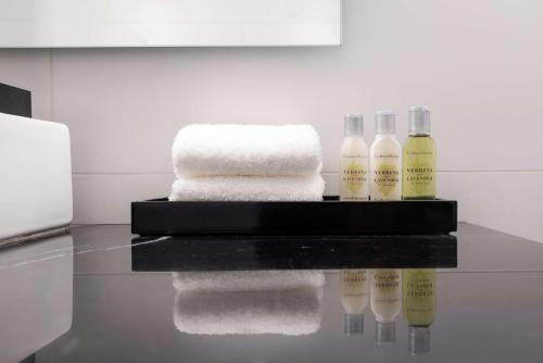a pile of towels on a counter in a bathroom at Soro Montevideo, Curio Collection By Hilton in Montevideo