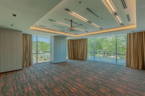 a large room with windows and a ceiling fan at Hilton Garden Inn Neuquen in Neuquén