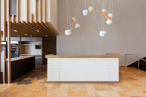 a kitchen with a white counter in a room at Hilton Garden Inn Mexico City Santa Fe in Mexico City