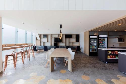 a dining room and kitchen with a table and chairs at Hilton Garden Inn Mexico City Santa Fe in Mexico City