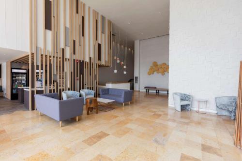 a lobby with couches and chairs in a building at Hilton Garden Inn Mexico City Santa Fe in Mexico City