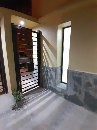 an empty room with a door and two windows at TresA -1- in Tres Arroyos
