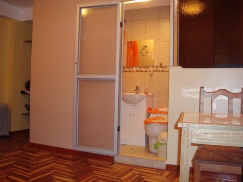 a bathroom with a toilet and a sink at Naty's Guest House in Cusco