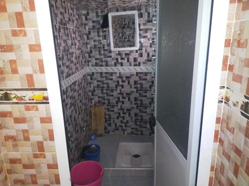 a small shower with a toilet in a bathroom at Dar Si Tawfik for Couples and Famillies in Chefchaouene