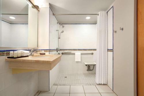 a bathroom with a sink and a shower at Embassy Suites by Hilton Dorado del Mar Beach Resort in Dorado