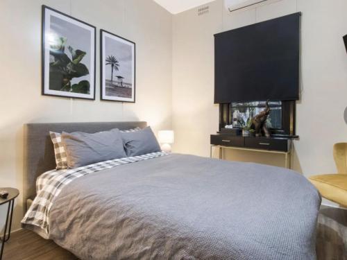 a bedroom with a bed and a flat screen tv at Royal hotel tambar springs 