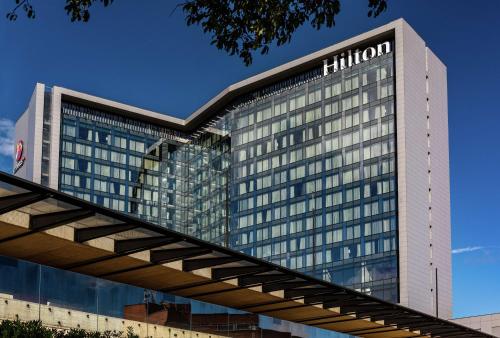 a hilton building with a sign on it at Hilton Bogota Corferias in Bogotá