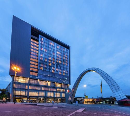 a large building with an arch in front of it at Hilton Bogota Corferias in Bogotá