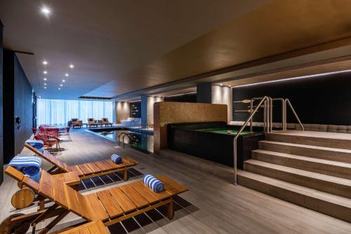 a living room with a pool table and stairs at Hilton Bogota Corferias in Bogotá