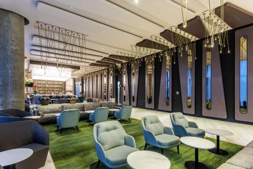 a waiting room with chairs and tables at Hilton Bogota Corferias in Bogotá