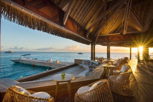 a restaurant on the beach with a view of the ocean at Conrad Bora Bora Nui in Bora Bora