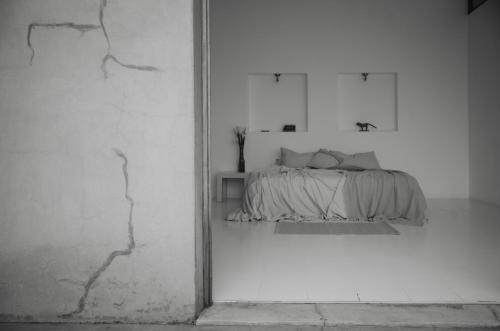 a bedroom with a bed in a white room at Anzan Atitlan in San Marcos La Laguna