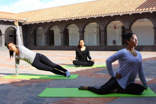 a group of women doing yoga in a courtyard at Hilton Garden Inn Cusco in Cusco