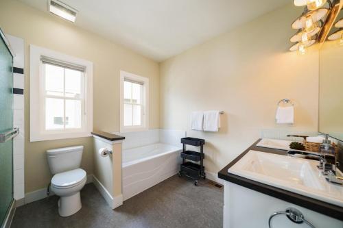 a bathroom with a tub and a toilet and a sink at More Cowbell! #63 in Chelan