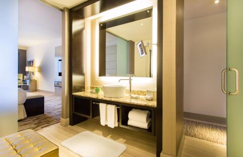 a bathroom with a sink and a mirror at Hilton Panama in Panama City