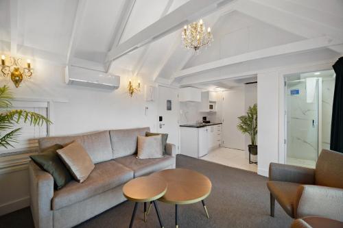 a living room with a couch and a table at Lakeview Colonial Motel in Queenstown