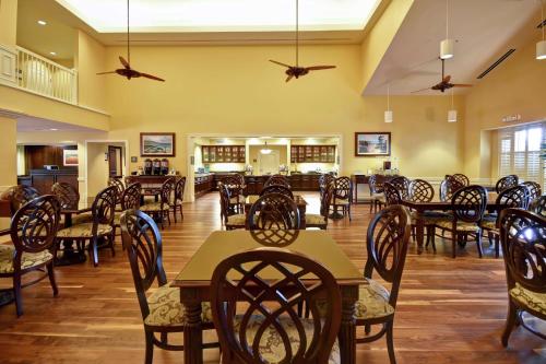 a dining room filled with wooden tables and chairs at Homewood Suites by Hilton Charleston Airport/Convention Center in Charleston
