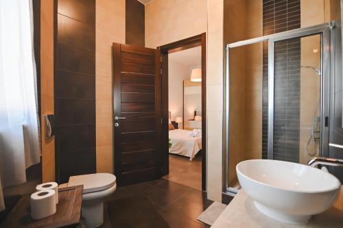 a bathroom with a sink and a toilet and a shower at Millennium Penthouse with private Hot Tub Gozo in Għajnsielem