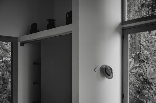 a shelf with vases on it next to a window at Anzan Atitlan in San Marcos La Laguna