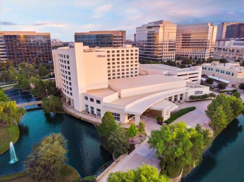 an aerial view of a building in a city at Hilton Dallas/Plano Granite Park in Plano