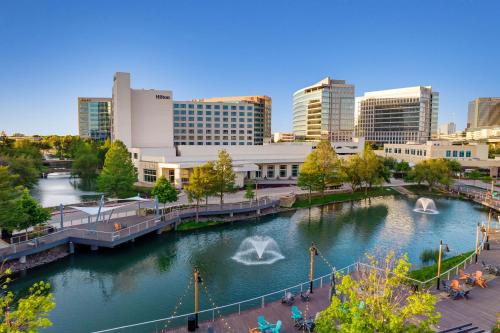 a view of a city with a river and buildings at Hilton Dallas/Plano Granite Park in Plano