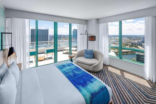 a bedroom with a large bed and a large window at The Diplomat Beach Resort Hollywood, Curio Collection by Hilton in Hollywood