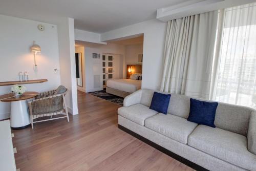 a living room with a couch and a bedroom at Hilton Fort Lauderdale Marina in Fort Lauderdale
