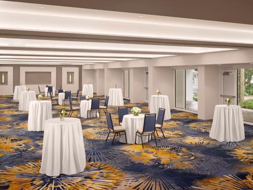 a ballroom with tables and chairs and white tables and chairs at Hilton Fort Lauderdale Marina in Fort Lauderdale