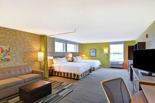 a hotel room with two beds and a flat screen tv at Home2 Suites By Hilton Helena in Helena