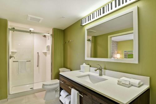 a bathroom with a sink and a toilet and a mirror at Home2 Suites By Hilton Helena in Helena