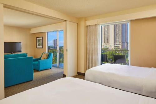 a hotel room with a bed and a large window at DoubleTree by Hilton Alana - Waikiki Beach in Honolulu