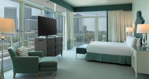 a hotel room with a bed and a television at The Beverly Hilton in Los Angeles