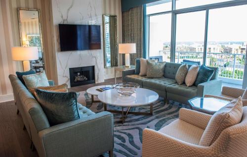 a living room with couches and a fireplace at The Beverly Hilton in Los Angeles