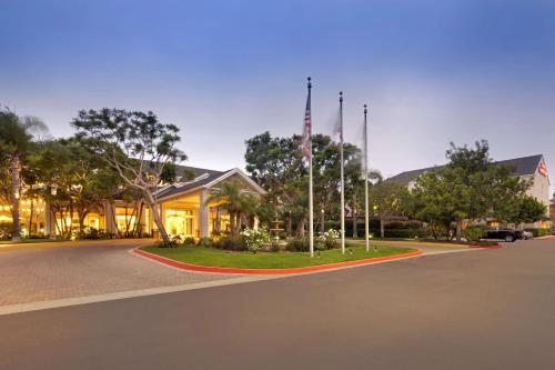 a building with a flag pole in the middle of a street at Hilton Garden Inn LAX - El Segundo in El Segundo