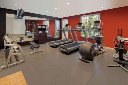 a gym with cardio equipment and red walls at Hilton Garden Inn LAX - El Segundo in El Segundo