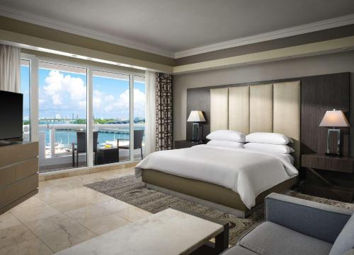 a bedroom with a large bed and a large window at DoubleTree by Hilton Grand Hotel Biscayne Bay in Miami