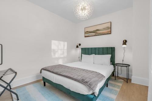 a bedroom with a bed and a chandelier at Beautiful Lakeside Haven in Port Hope