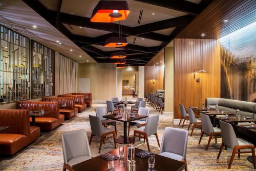 a restaurant with tables and couches and chairs at Hilton Minneapolis in Minneapolis