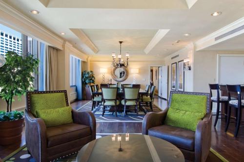 a living room with chairs and a table at Hilton Minneapolis in Minneapolis