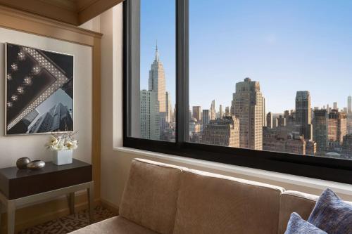 a room with a window with a view of the city at Hilton New York Times Square in New York