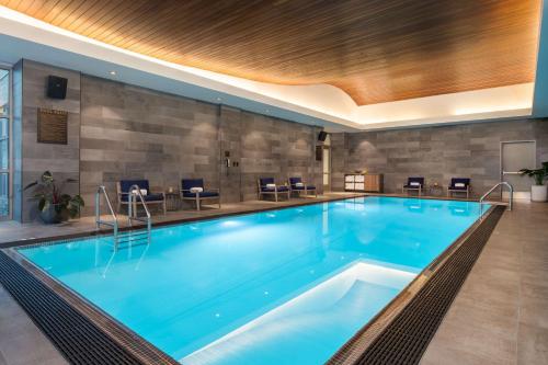 a large swimming pool in a hotel room at The Duniway Portland, A Hilton Hotel in Portland