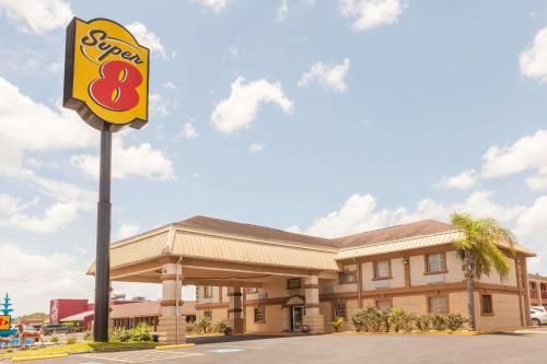 a fast food restaurant with a sign in front of it at Super 8 by Wyndham Kingsville in Kingsville