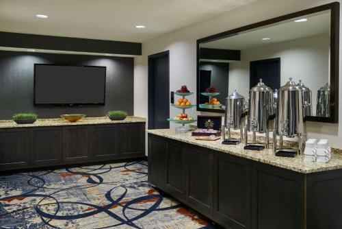 a hotel lobby with a reception desk and a tv at The Inn at Penn, A Hilton Hotel in Philadelphia